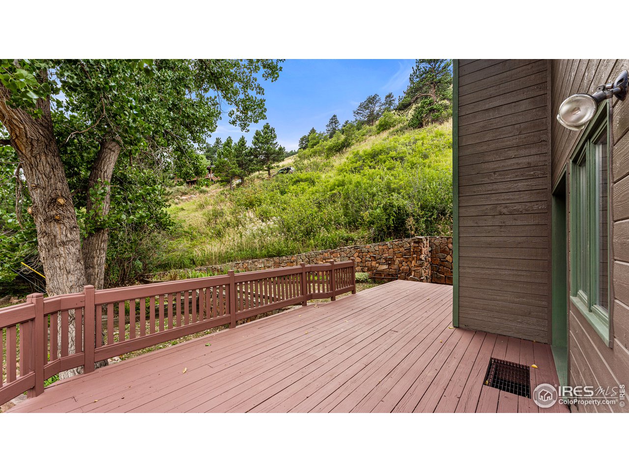 7333 Olde Stage Road Boulder, CO 80302 - Photo 12 of 40 a balcony with wooden floor and bench
