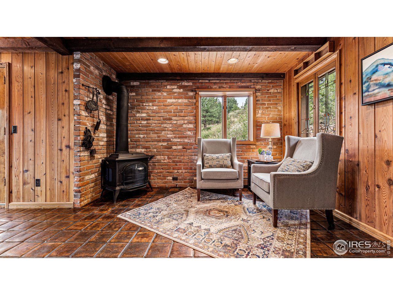 7333 Olde Stage Road Boulder, CO 80302 - Photo 14 of 40 a living room with furniture a flat screen tv and a fireplace