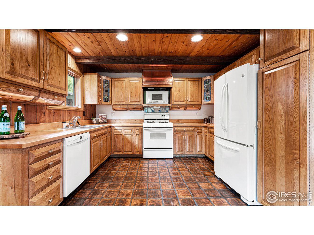 7333 Olde Stage Road Boulder, CO 80302 - Photo 15 of 40 a kitchen with a refrigerator and white cabinets