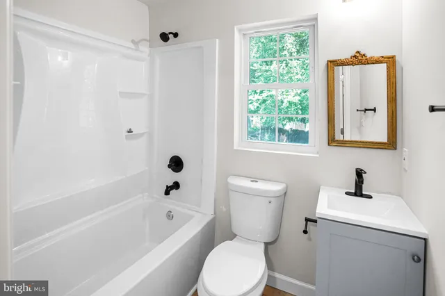 a bathroom with a toilet a sink and a bathtub
