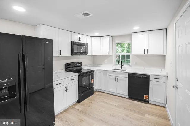 a kitchen with a refrigerator stove and sink