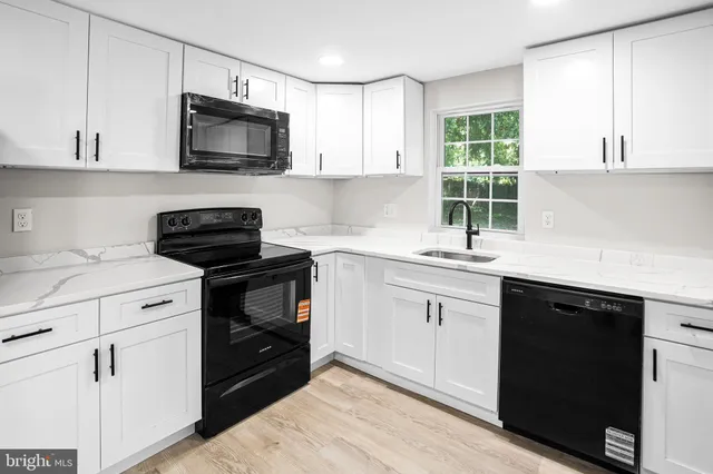 a kitchen with a sink stove and microwave