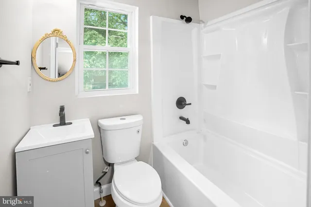 a bathroom with a sink a toilet and a bathtub