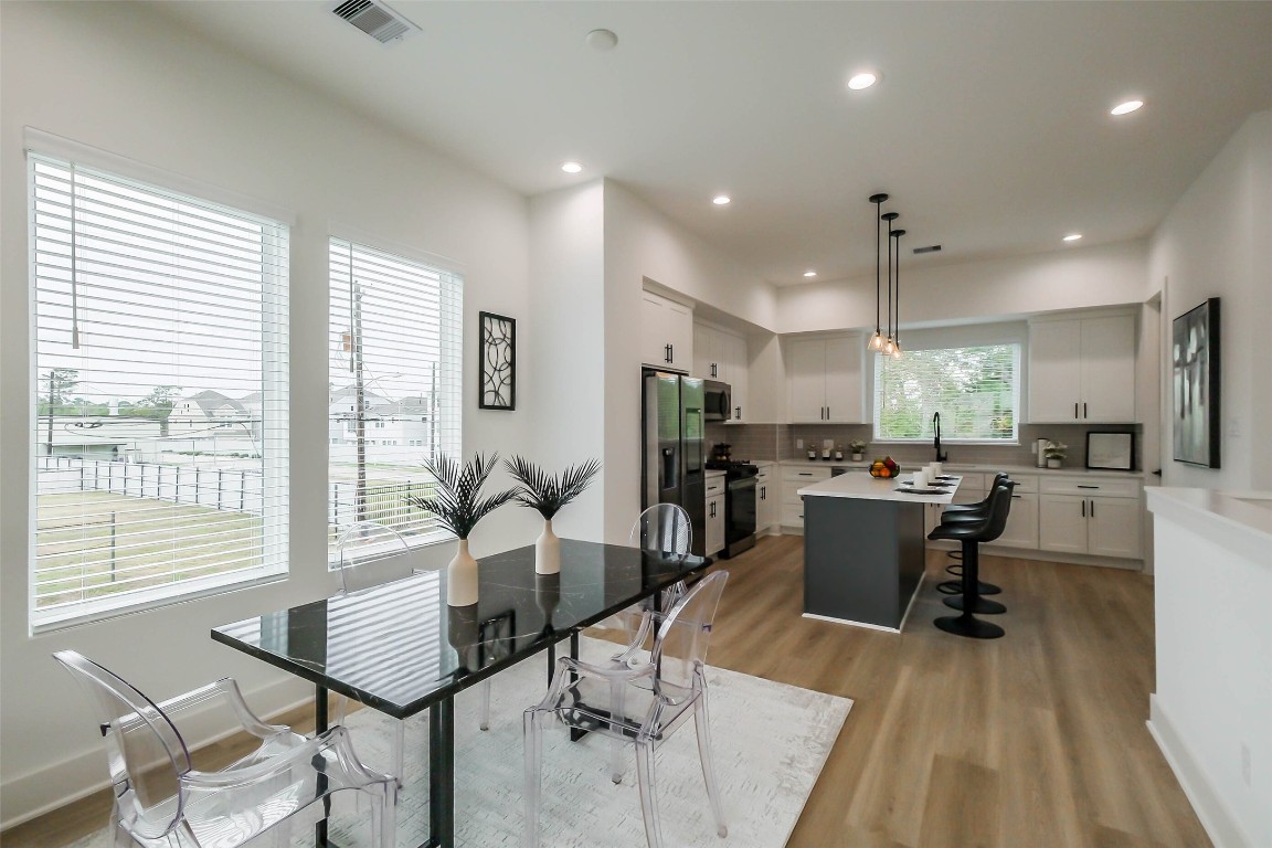 5703 B Balbo Street Houston, TX 77091 - Photo 12 of 46 a view of a dining room with furniture and wooden floor