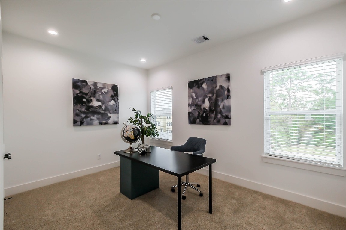 5703 B Balbo Street Houston, TX 77091 - Photo 22 of 46 a view of a workspace with furniture and a window