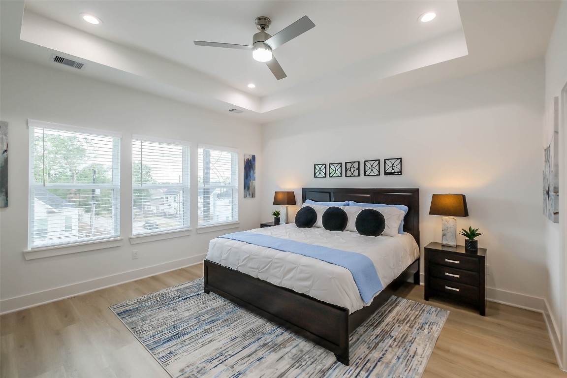 5703 B Balbo Street Houston, TX 77091 - Photo 26 of 46 a bedroom with a large bed and a lamp