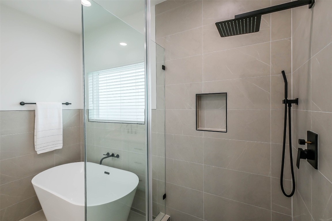 5703 B Balbo Street Houston, TX 77091 - Photo 28 of 46 a bathroom with a tub and shower