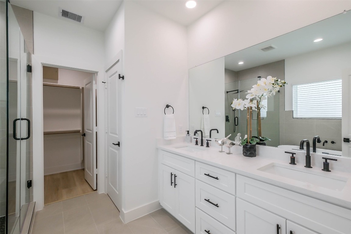 5703 B Balbo Street Houston, TX 77091 - Photo 29 of 46 a bathroom with a double vanity sink mirror and shower
