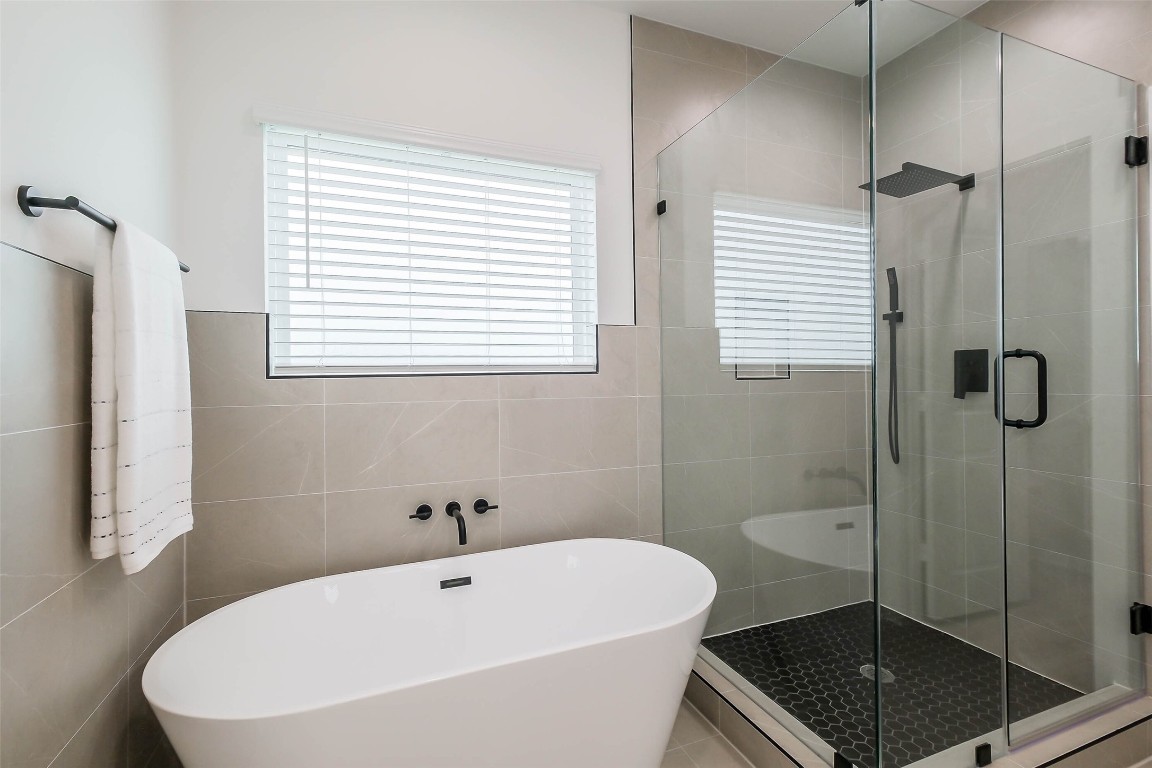 5703 B Balbo Street Houston, TX 77091 - Photo 30 of 46 a white bath tub sitting next to a shower