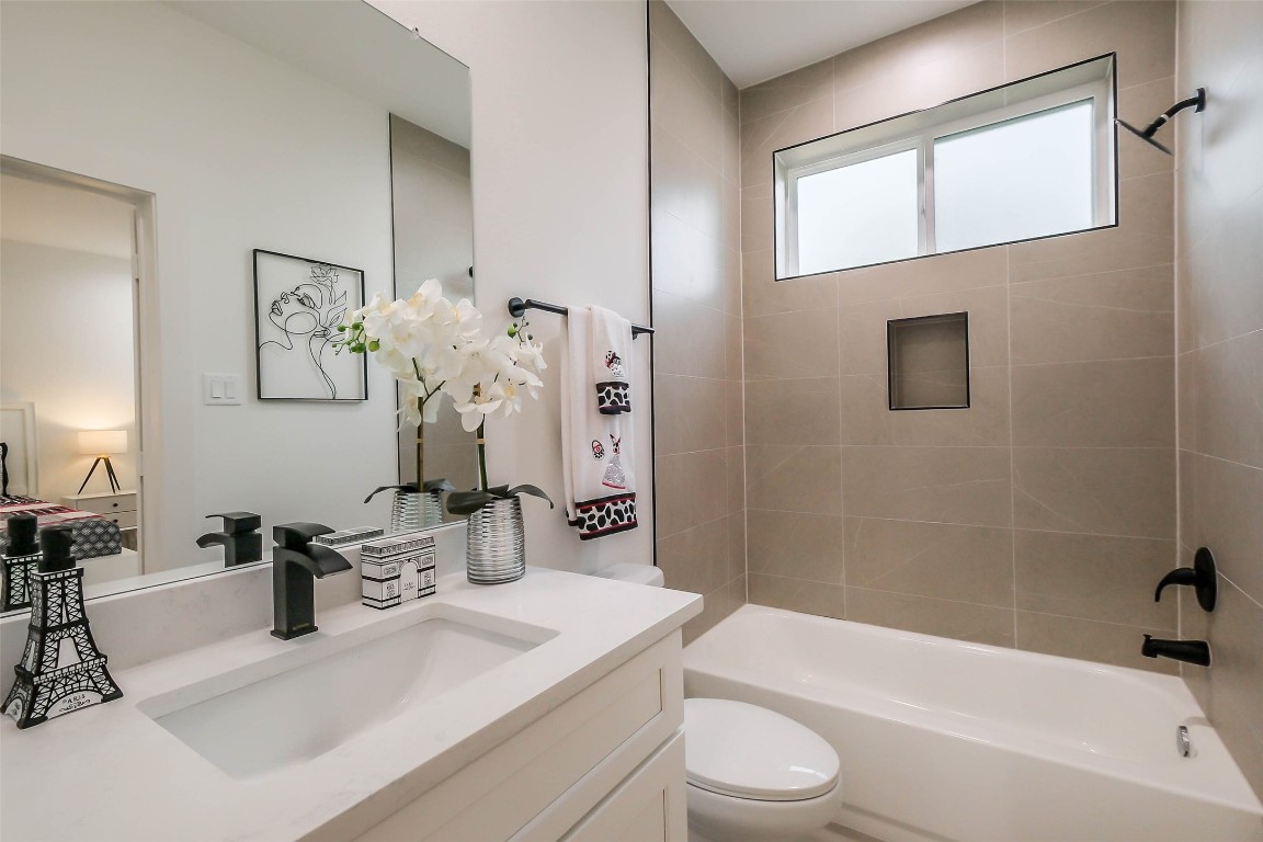 5703 B Balbo Street Houston, TX 77091 - Photo 35 of 46 a bathroom with a sink a toilet and bathtub
