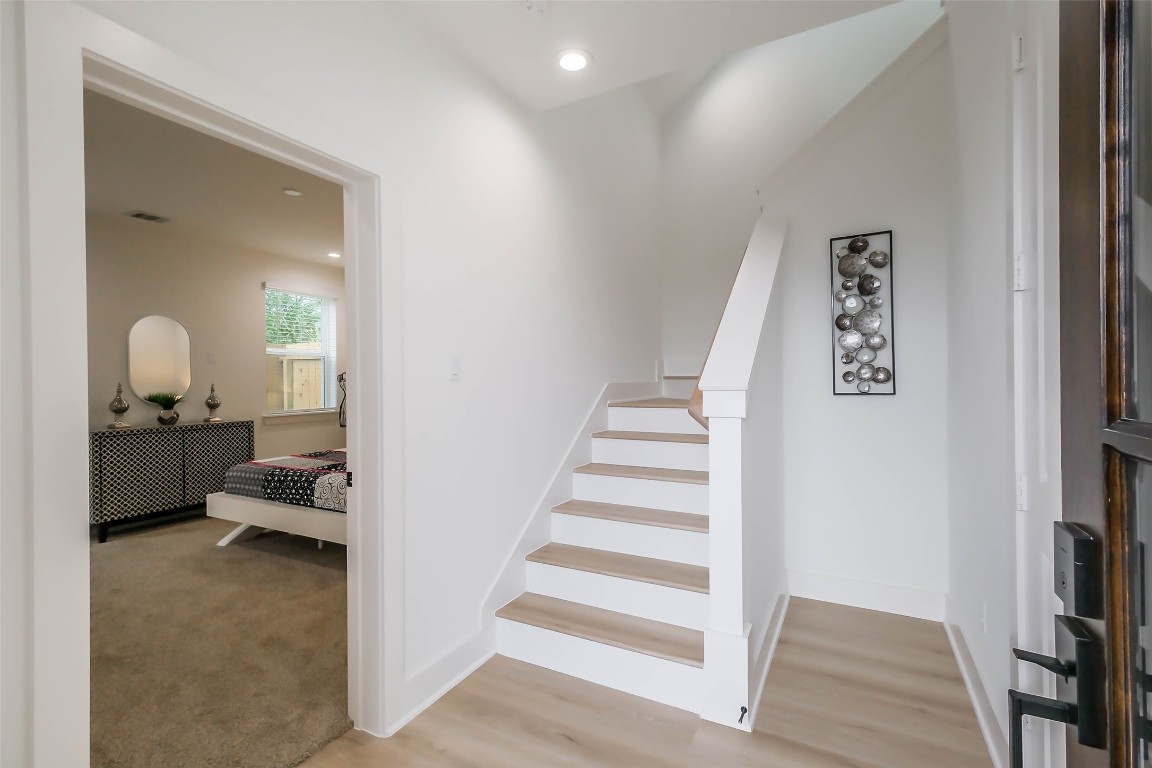 5703 B Balbo Street Houston, TX 77091 - Photo 5 of 46 a view of a hallway with bedroom and stairs