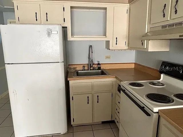 a white refrigerator freezer sitting inside of a kitchen