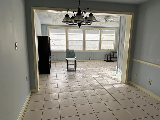 a room with granite countertop a sink and a window