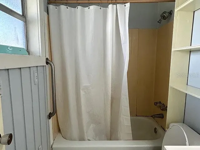 a bathroom with sink toilet and shower