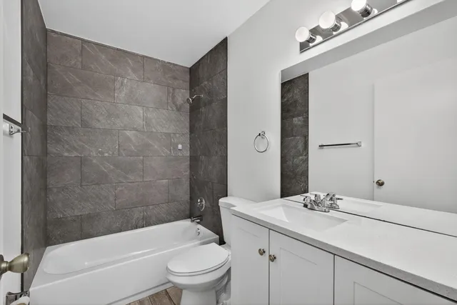 a bathroom with a double vanity sink mirror and toilet