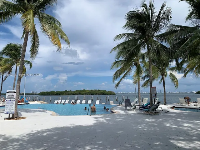 a swimming pool with outdoor seating and yard