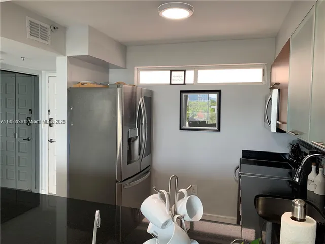 a kitchen with a refrigerator and a refrigerator