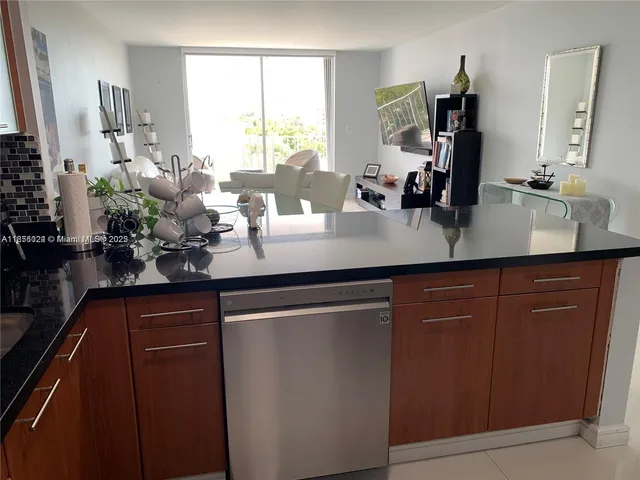 a kitchen with sink refrigerator and window