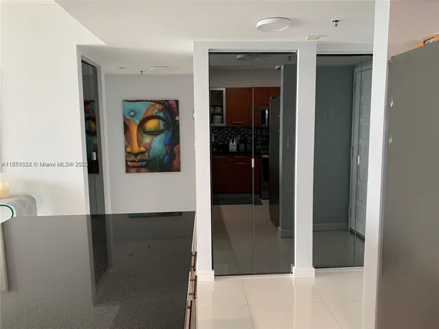 a view of a hallway with a painting on the wall