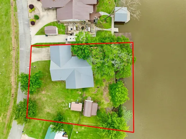 an aerial view of residential house with outdoor space and swimming pool