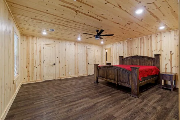 a spacious bedroom with a bed and a table