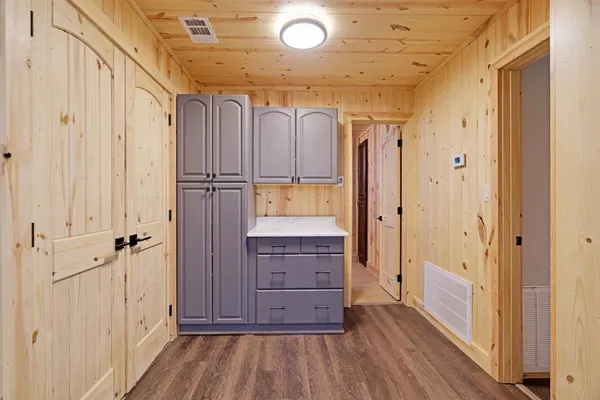 a view of a hallway with wooden floor