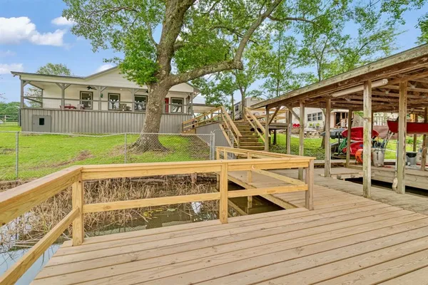 a view of house with swimming pool and sitting area