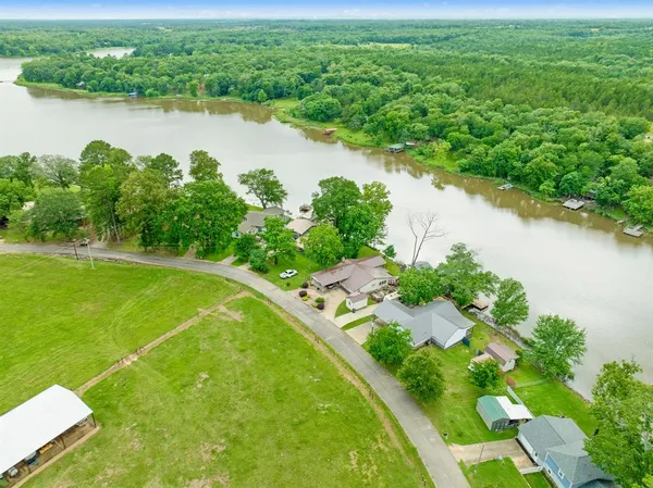 an aerial view of a houses with a lake view