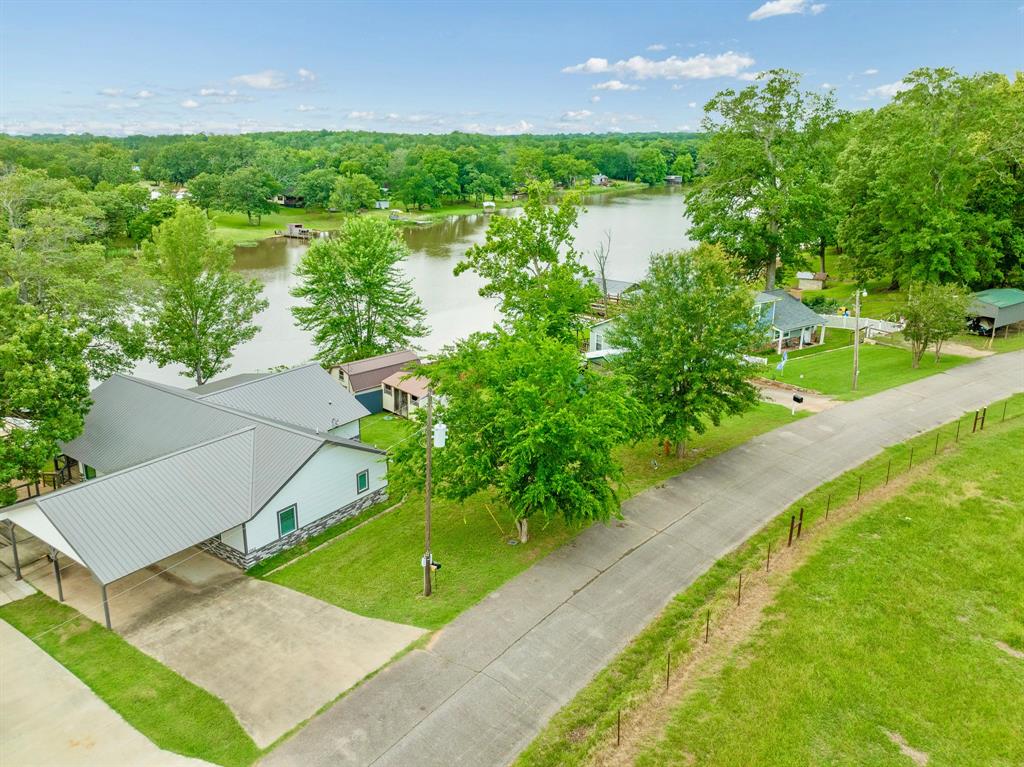1205 Lakeside Drive Fort Towson, OK 74735 - Photo 5 of 38 a view of a lake with a yard and potted plants