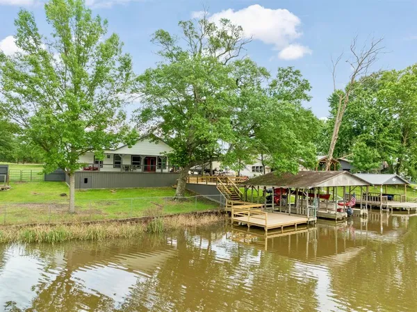 a view of an house with swimming pool and trees in the background