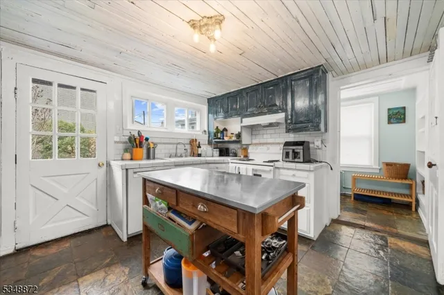 a kitchen with stainless steel appliances a sink and a refrigerator