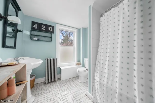 a bathroom with a sink a toilet and a shower