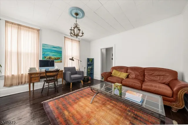 a living room with furniture rug and wooden floor