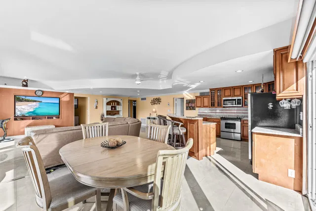a dining room with furniture water view and pool side view