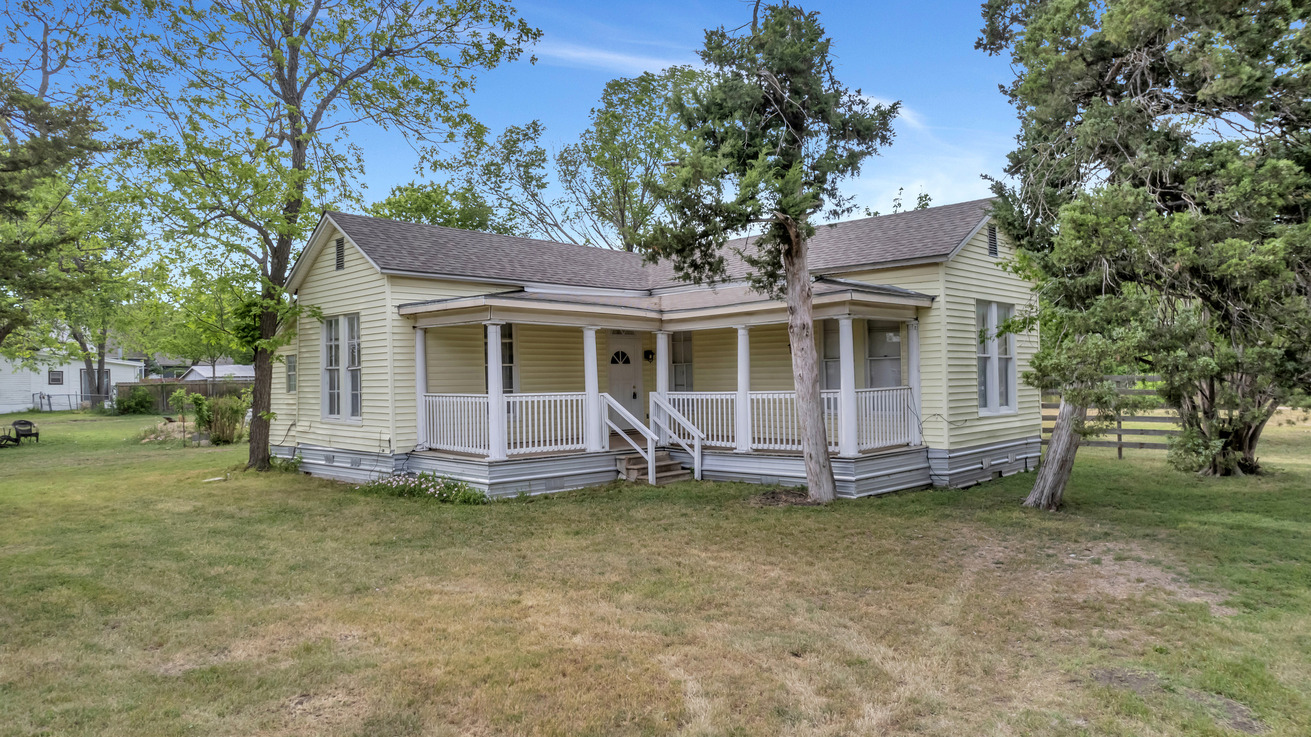401 Shaw Street Taylor, TX 76574 - Photo 1 of 1 Bungalow featuring a shingled roof, a front lawn, and covered porch
