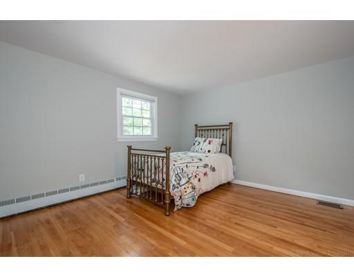 61 Maynard Road Sudbury, MA 01776 - Photo 17 of 38 a bedroom with a bed and wooden floor