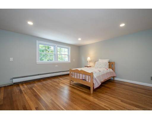 61 Maynard Road Sudbury, MA 01776 - Photo 26 of 38 a spacious bedroom with a bed and a window