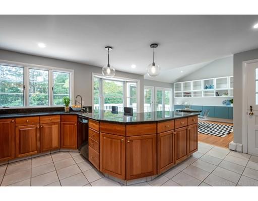 61 Maynard Road Sudbury, MA 01776 - Photo 6 of 38 a kitchen with stainless steel appliances granite countertop a stove a sink dishwasher and cabinets with wooden floor