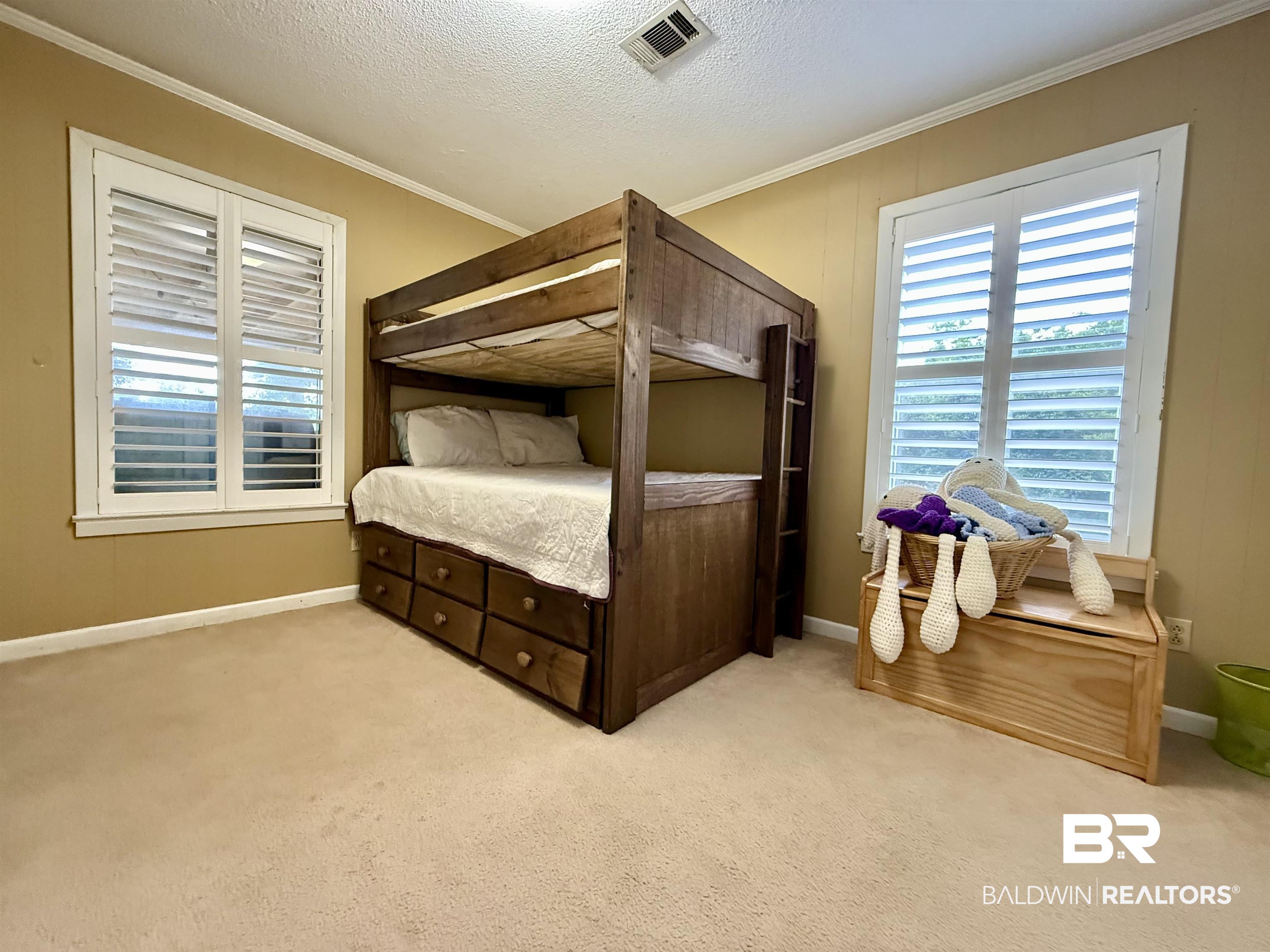 5971 Appleton Road Brewton, AL 36426 - Photo 14 of 23 Bedroom with ornamental molding, carpet, and a textured ceiling