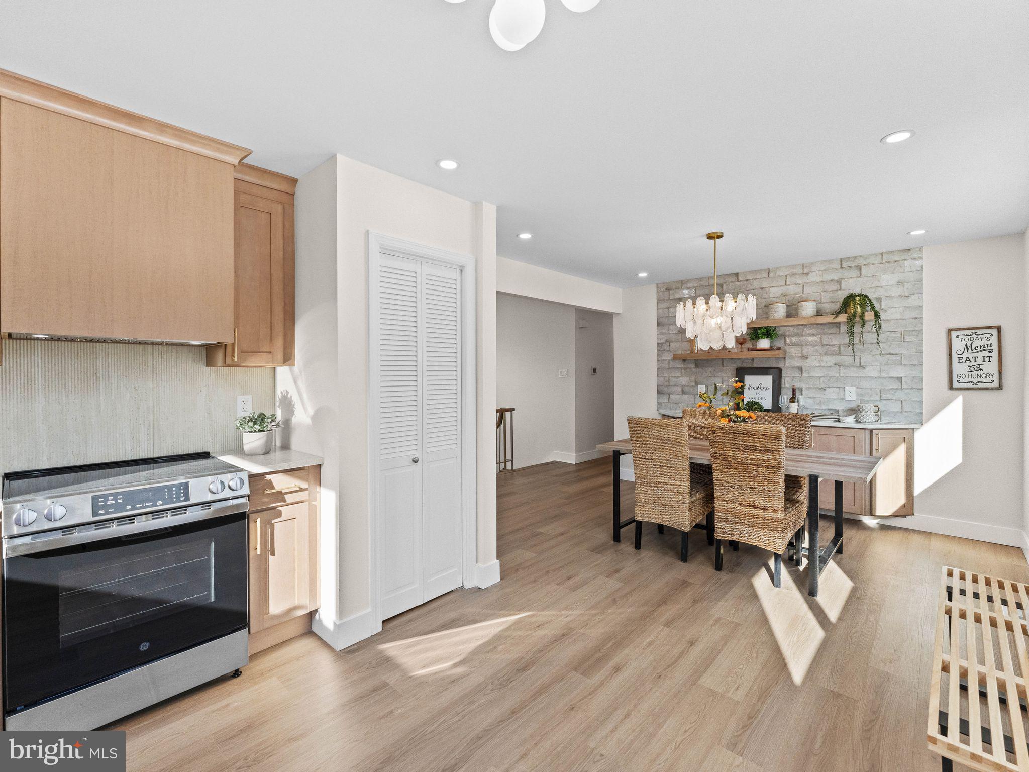 366 Independence Boulevard Lawnside, NJ 08045 - Photo 18 of 41 a kitchen with stainless steel appliances a stove a sink cabinets and wooden floor