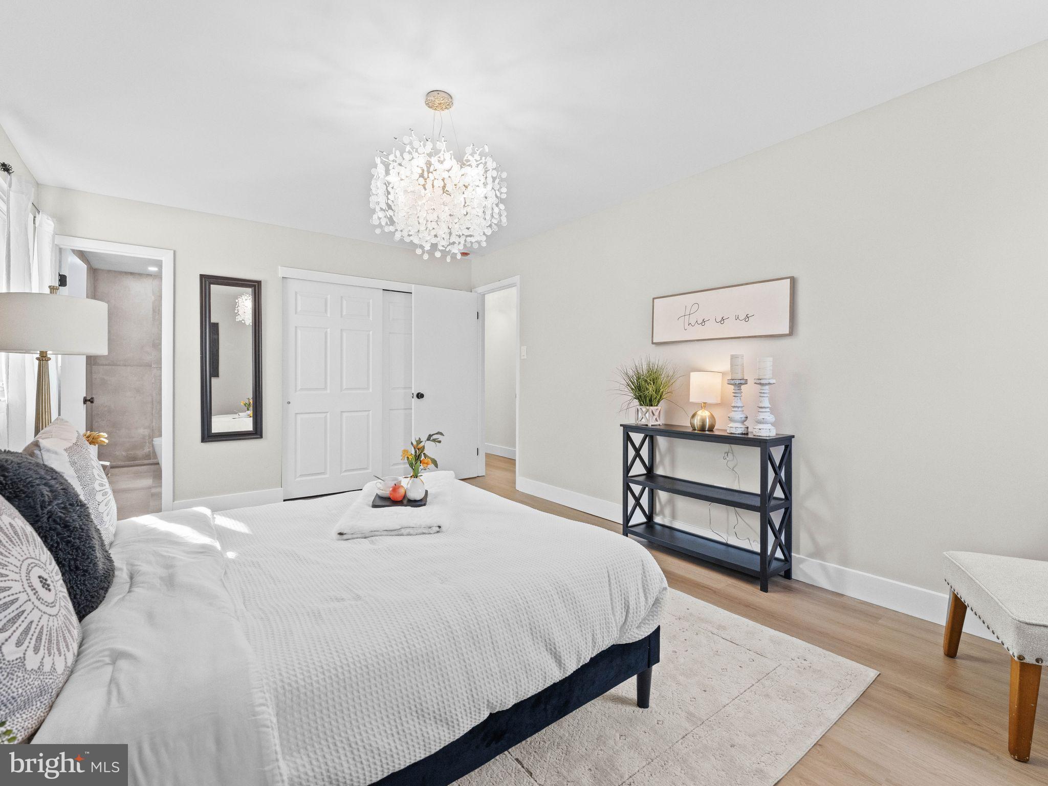 366 Independence Boulevard Lawnside, NJ 08045 - Photo 20 of 41 a bedroom with a bed and a chandelier