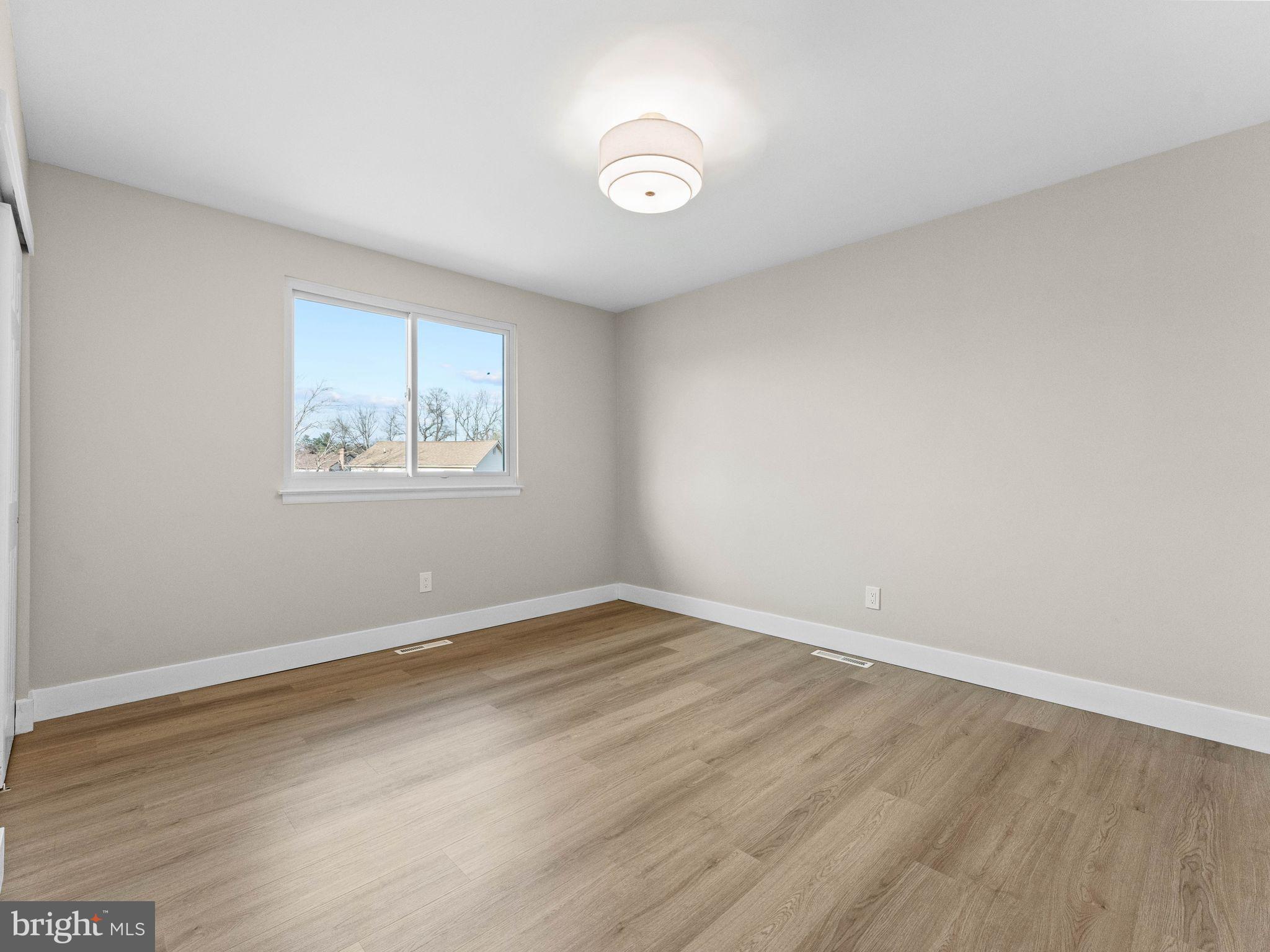 366 Independence Boulevard Lawnside, NJ 08045 - Photo 23 of 41 an empty room with wooden floor and windows