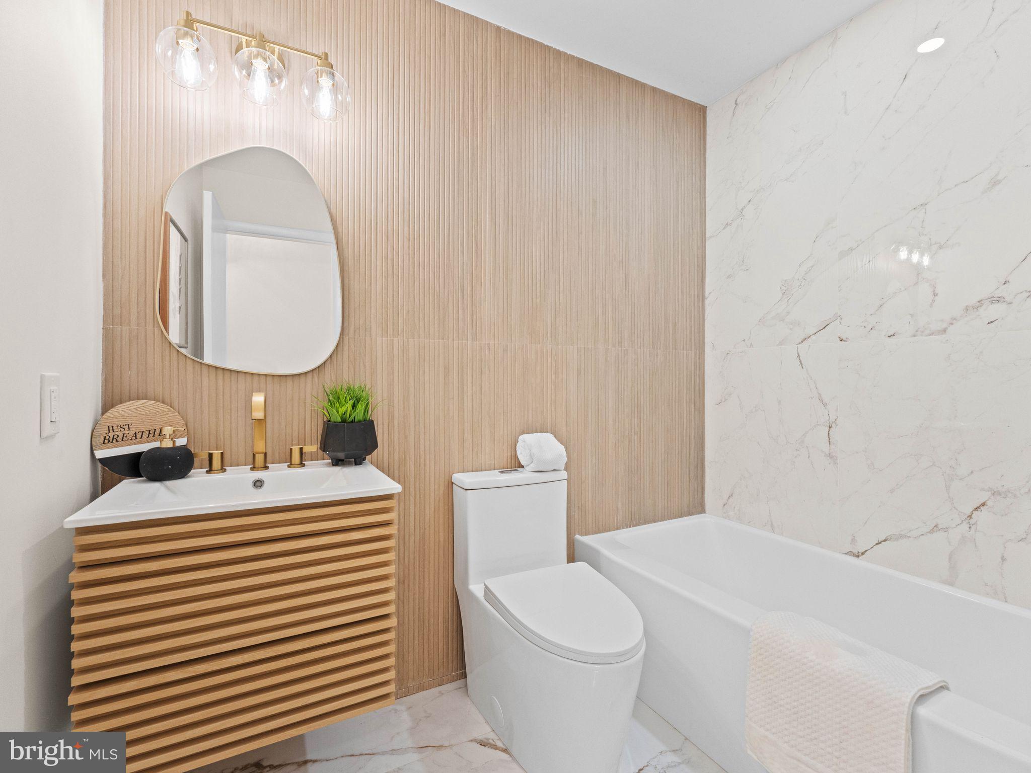 366 Independence Boulevard Lawnside, NJ 08045 - Photo 27 of 41 a bathroom with a sink a toilet and a mirror