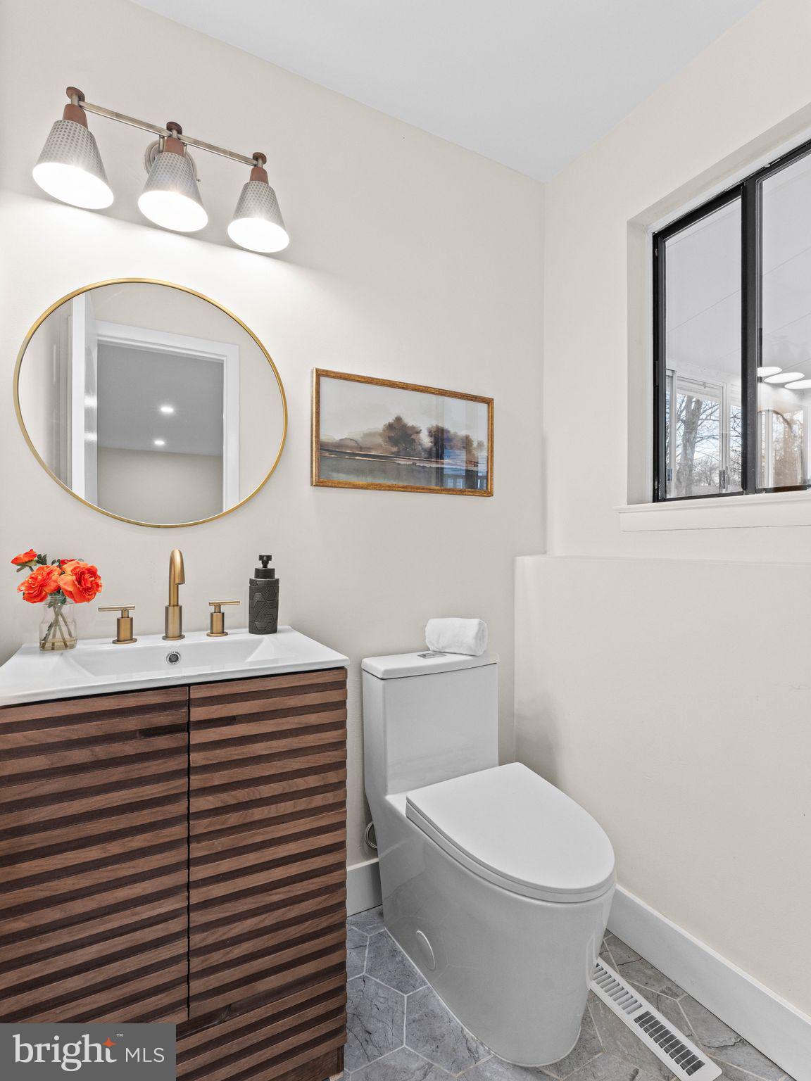 366 Independence Boulevard Lawnside, NJ 08045 - Photo 33 of 41 a bathroom with a toilet a sink and mirror