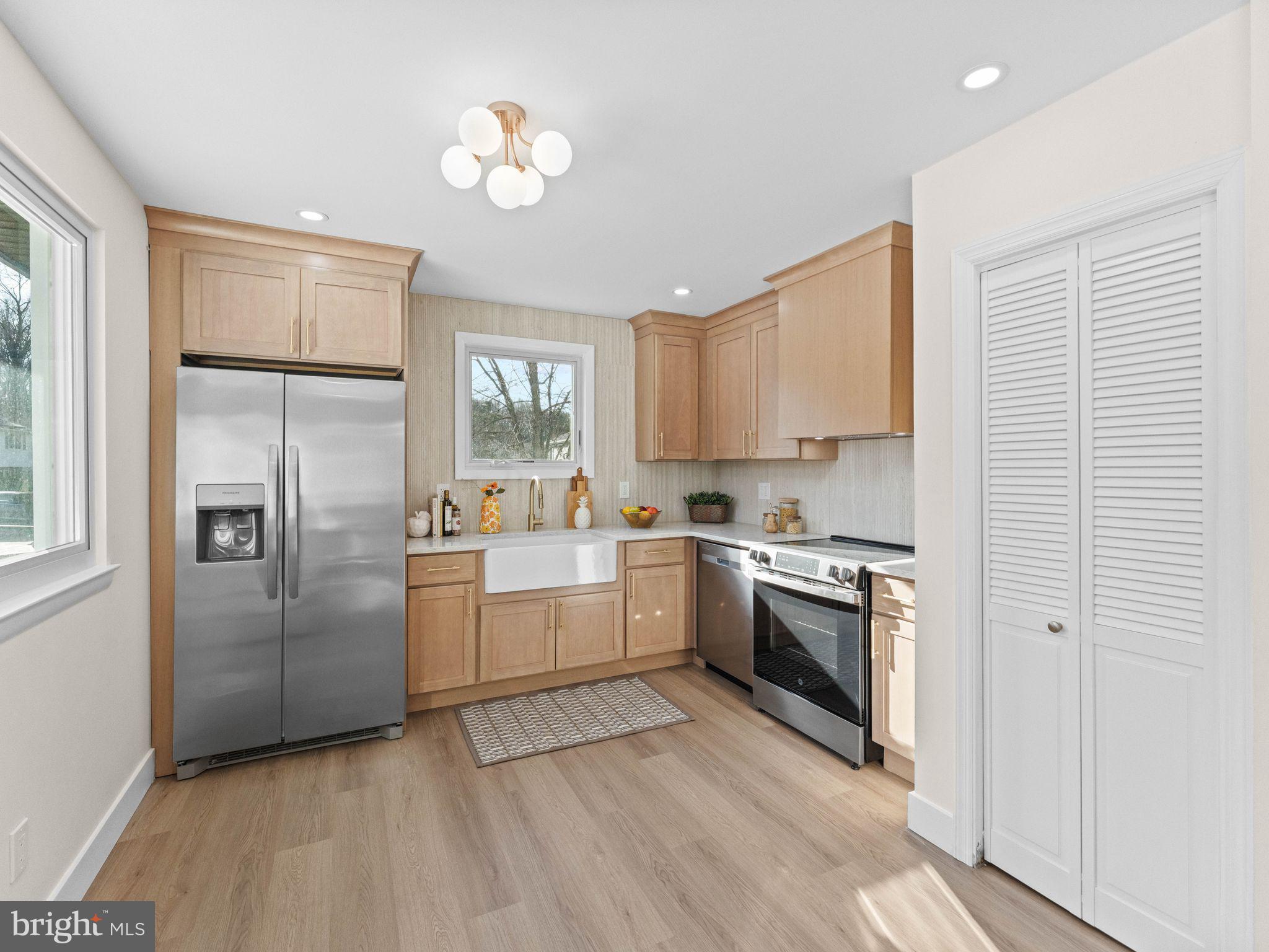 366 Independence Boulevard Lawnside, NJ 08045 - Photo 4 of 41 a kitchen with a refrigerator sink and cabinets
