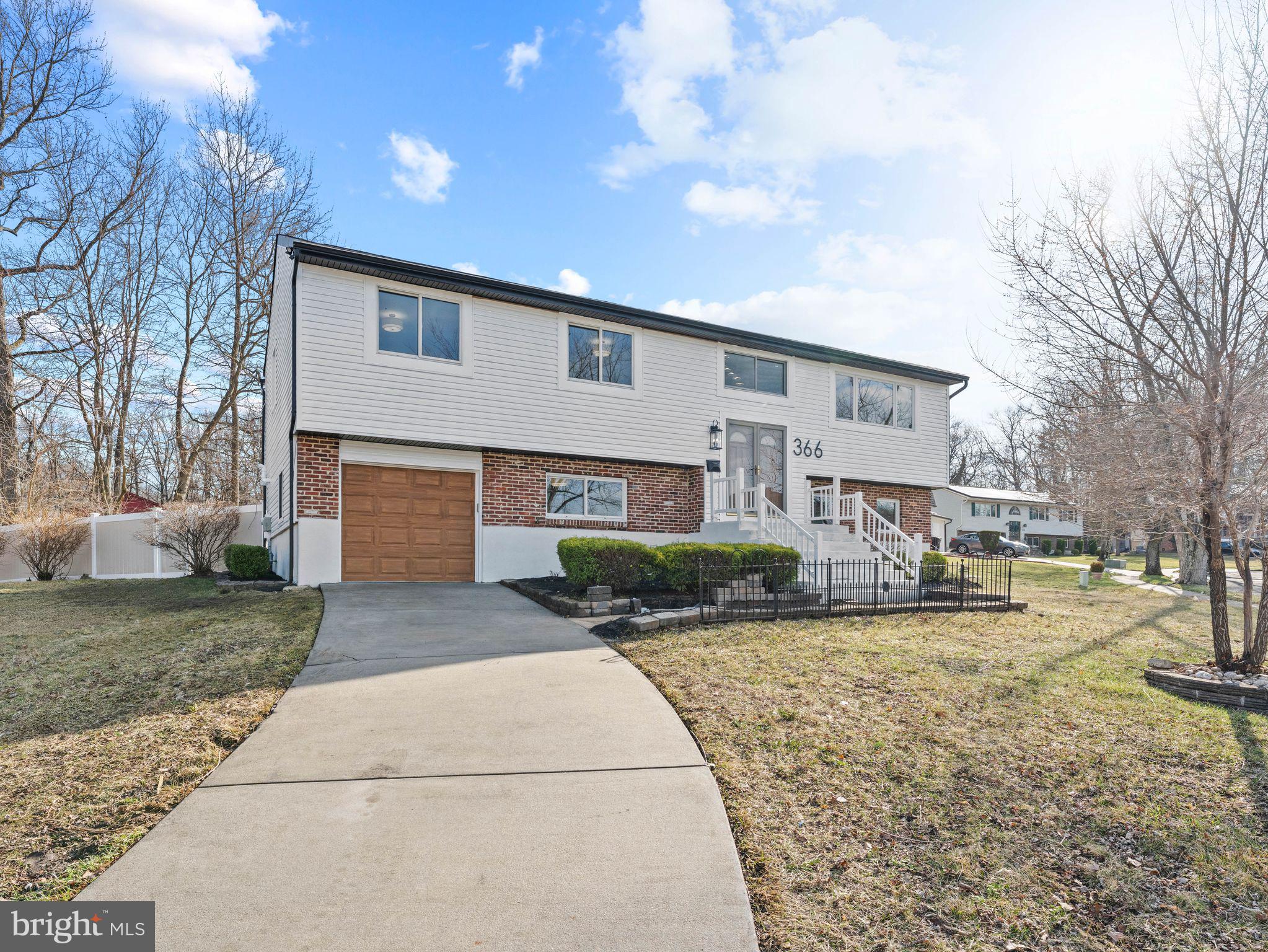 366 Independence Boulevard Lawnside, NJ 08045 - Photo 7 of 41 a front view of a house with a yard and garage
