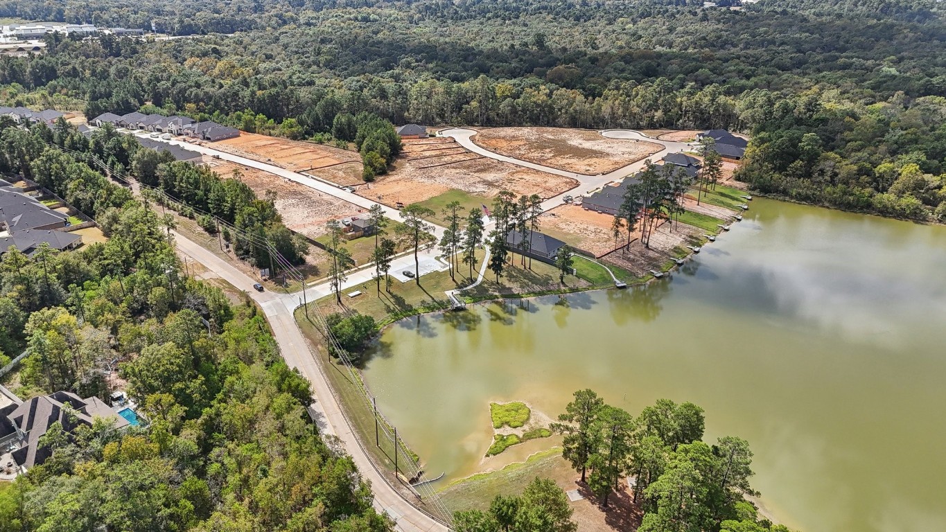 407 Summerset Landing Court Conroe, TX 77304 - Photo 14 of 15 an aerial view of residential houses with outdoor space and lake view