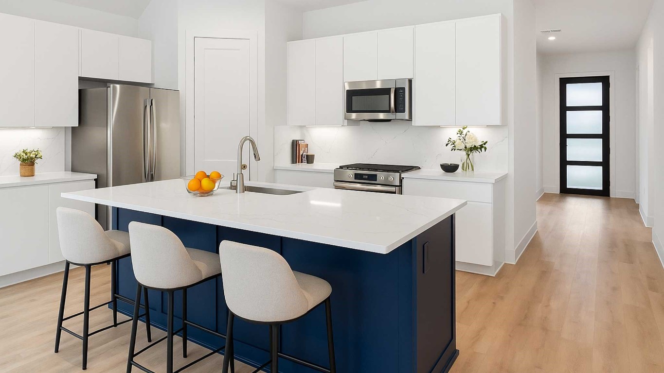 407 Summerset Landing Court Conroe, TX 77304 - Photo 2 of 15 a kitchen with stainless steel appliances a stove a sink a microwave a refrigerator a counter space and cabinets