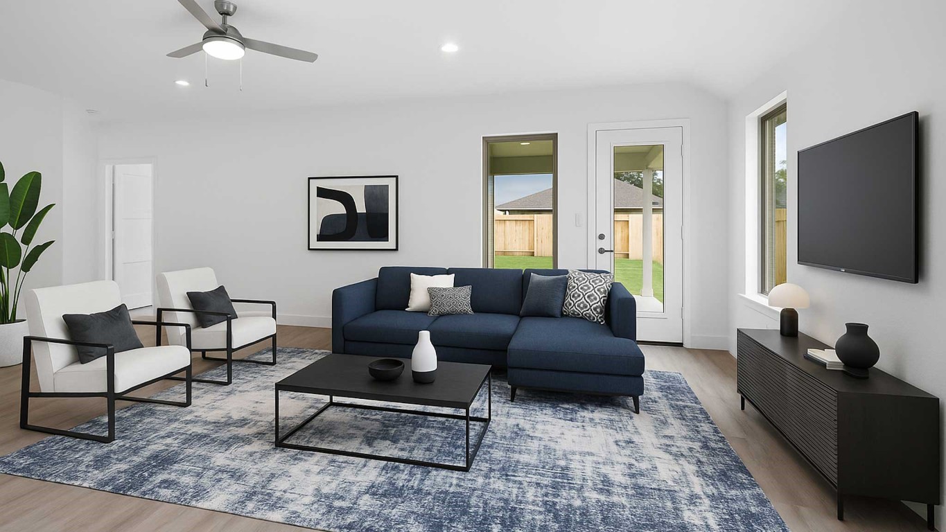407 Summerset Landing Court Conroe, TX 77304 - Photo 3 of 15 a living room with furniture a flat screen tv and a window
