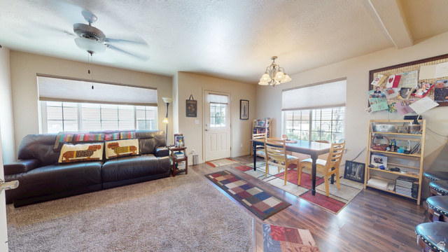1674 Eastridge Road Price, UT 84501 - Photo 12 of 34 Open-concept living space with neutral paint, plush carpet, and wood-finish flooring